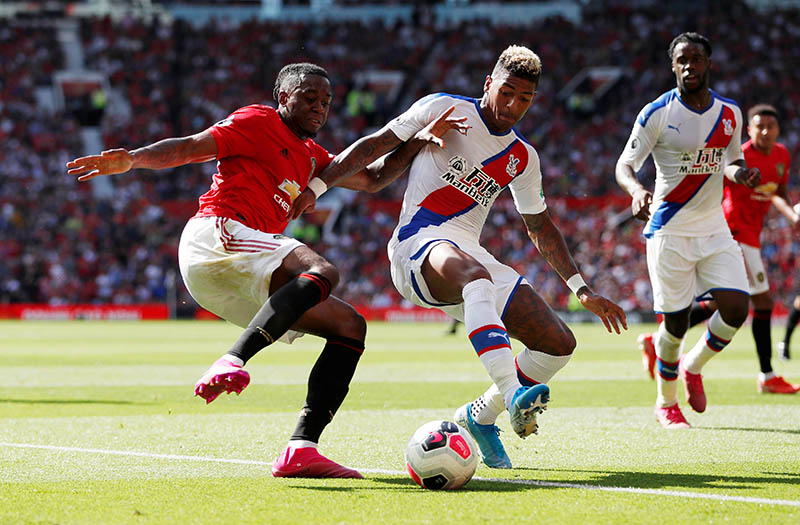 Manchester United's Aaron Wan-Bissaka in action with Crystal Palace's Patrick van Aanholt during the Premier League match between Manchester United and Crystal Palace, at Old Trafford, in Manchester, Britain, on August 24, 2019. Photo: Action Images via Reuters