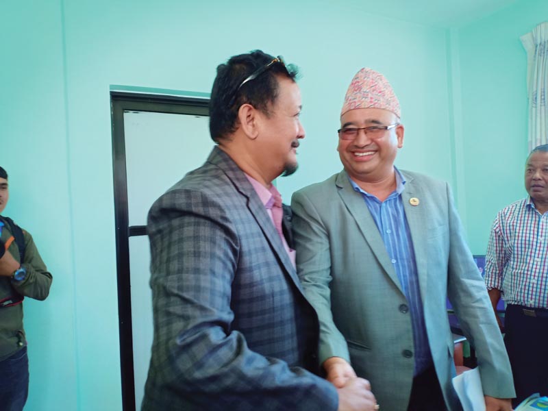 NOC President Jeevan Ram Shrestha (right) shakes hands with former vice-president Umesh Lal Shrestha before filing nomination papers in Lalitpur on Tuesday, August 27, 2019. Photo: THT