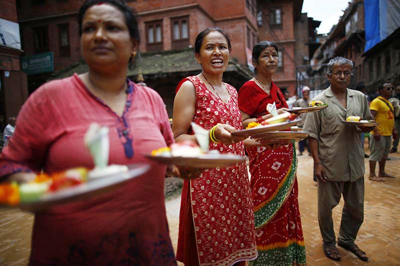Devotees wait to pay obeisance to the idol of Dipankar Buddha, carrying offerings during Pancha Daan festival, in Bhaktapur, on Wednesday, August 28, 2019. Photo: Skanda Gautam/THT