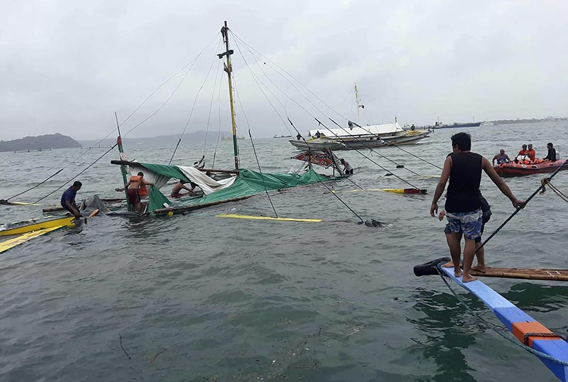 Rescuers checks the remains of a ferry boat after it capsized due to bad weather in the waters between Guimaras and Iloilo provinces, central Philippines on Saturday August 3, 2019. Photo: Philippine Red Cross via AP
