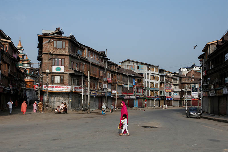 FILE: Residents cross a street during restrictions in Srinagar, August 5, 2019. Photo: Reuters