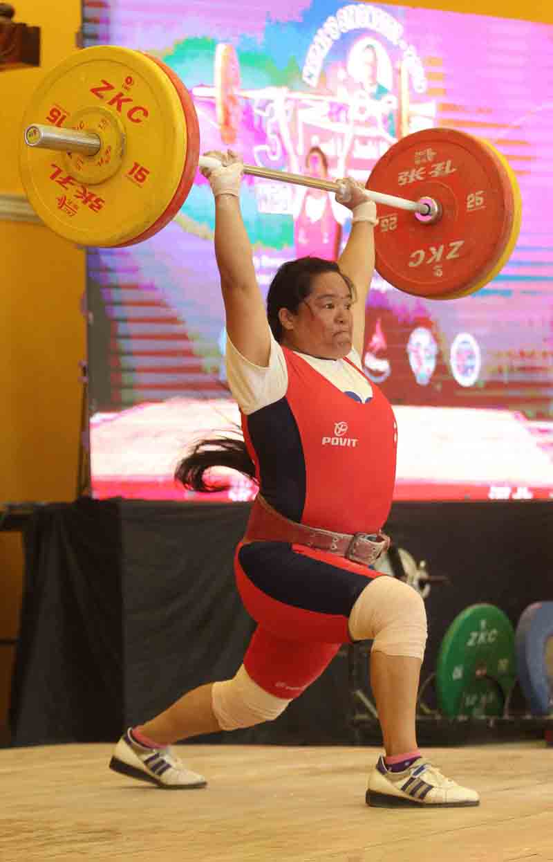 Tara Devi Pun of Nepal Police Club lifts 98 kg clean and jerk in women's 76 kg category during the third Olympian Sunil Lal Joshi Memorial National Weightlifting Championship at Marutole in Kathmandu on Wednesday. Photo: THT