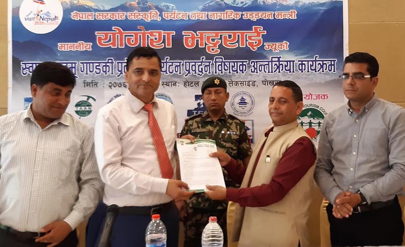Minister of Culture, Tourism and Civil Aviation Yogesh Bhattarai receiving a memorandum from Pokhara Tourism Council Chairman Chiranjibi Pokhrel on the development of tourism, in Pokhara, on Wednesday, August 29, 2019.Photo: THT