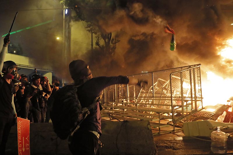 A protestor throws a molotov cocktail towards a barrier in Hong Kong  on August 31, 2019. Photo: AP