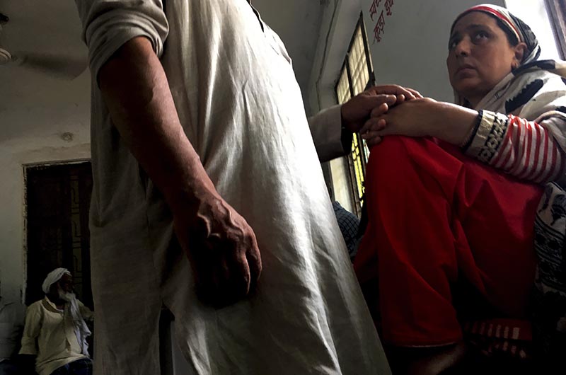 A Kashmiri man comforts his wife inside the waiting room of Agra Central Jail as they wait for their turn to meet their son in Agra, India, Friday, Sept. 20, 2019. Photo: AP