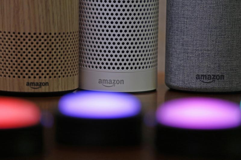 FILE - In this September 27, 2017, file photo, Amazon Echo and Echo Plus devices, behind, sit near illuminated Echo Button devices during an event announcing several new Amazon products by the company in Seattle. Photo: AP