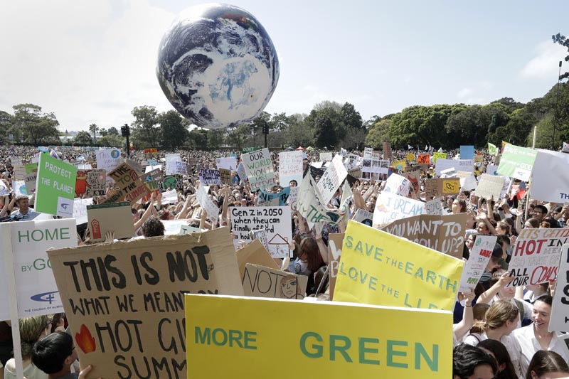 A large inflatable globe is bounced through the crowd as thousands of protestors, many of them school students, gather in Sydney, Friday, September 20, 2019, calling for action to guard against climate change. Photo: AP