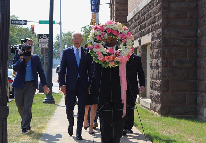 Former Vice President and presidential candidate Joe Biden, center left, joins Sen. Doug Jones and Birmingham Mayor Randall Woodfin at a wreath laying after a service at 16th Street Baptist Church in Birmingham, Ala., Sunday, on Sept.15, 2019. Photo: AP