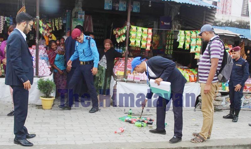 A market monitoring team destroying date-expired cold drinks at the bus park in Dhankuta Municipality, on Wednesday, September 25, 2019. Photo: THT