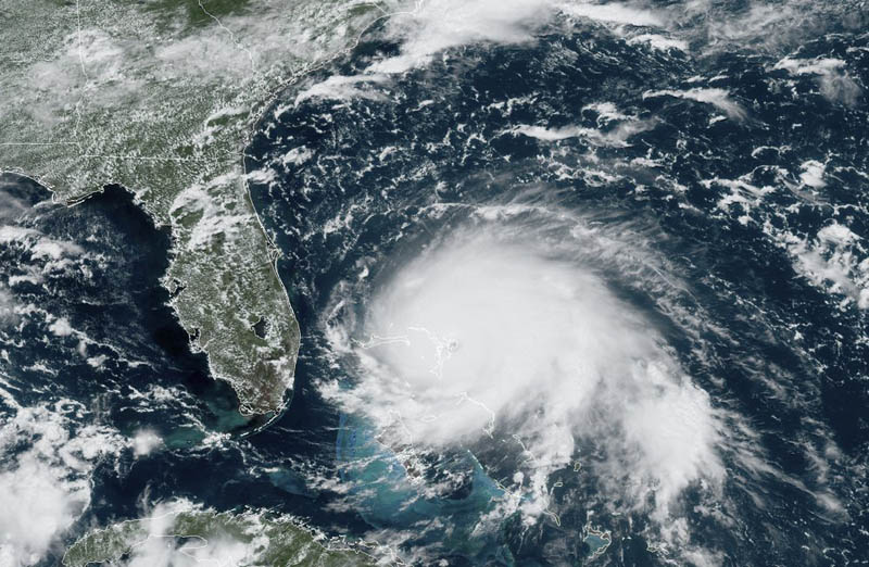 This GOES-16 satellite image taken Sunday, Septemebr 1, 2019, at 17:00 UTC and provided by National Oceanic and Atmospheric Administration (NOAA), shows Hurricane Dorian, right, churning over the Atlantic Ocean.