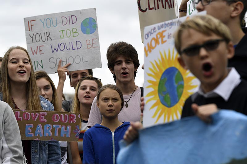 Swedish youth climate activist Greta Thunberg, center in blue, joins other young climate activists Friday for a climate strike outside the White House in Washington, Friday on Sept. 13, 2019. Photo: AP