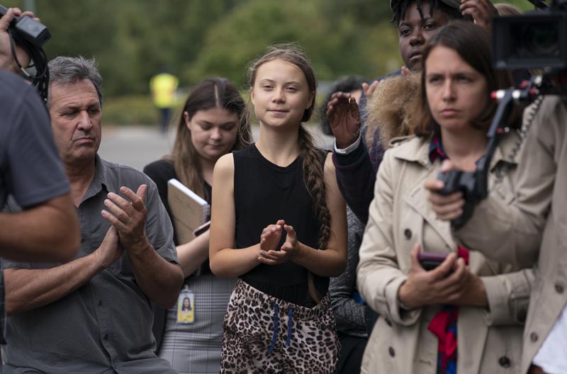 Swedish activist Greta Thunberg (centre) who has called on world leaders to step up their efforts against global warming, applauds remarks by Senator Ed Markey, D-Mass, chairman of the Senate Climate Change Task Force, at a news conference at the Capitol in Washington, Tuesday, September 17, 2019. Photo: AP