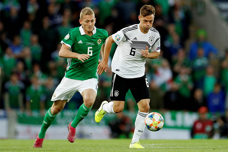 Germany's Joshua Kimmich in action with Northern Ireland's George Saville. Photo: Reuters
