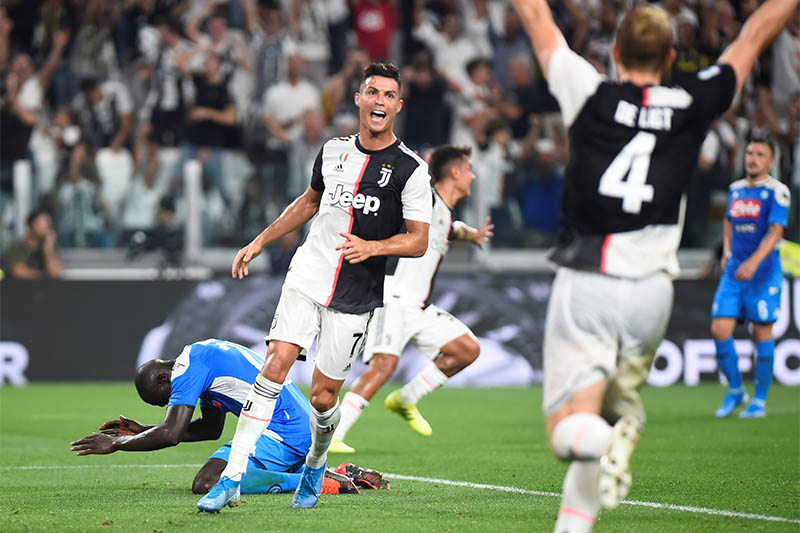 Napoli's Kalidou Koulibaly looks dejected after scoring an own goal and Juventus' fourth as Juventus' Cristiano Ronaldo and Matthijs de Ligt celebrate. Photo: Reuters