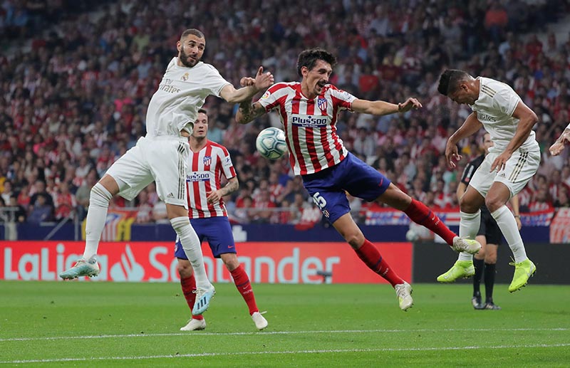 Atletico Madrid's Stefan Savic in action with Real Madrid's Casemiro and Karim Benzema during the La Liga Santander match between Atletico Madrid and Real Madrid, at Wanda Metropolitano, in Madrid, Spain, on September 28, 2019. Photo: Reuters