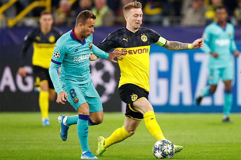 Barcelona's Arthur in action with Borussia Dortmund's Marco Reus. Photo: Reuters