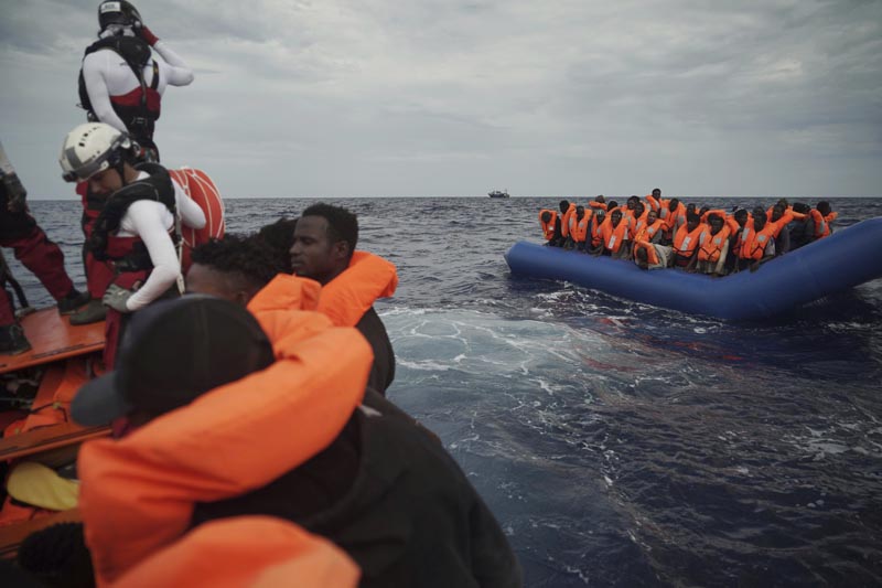 Migrants on a blue rubber boat wait to be rescued some 14 nautical miles from the coast of Libya in Mediterranean Sea, Sunday, September 8, 2019. Photo: AP