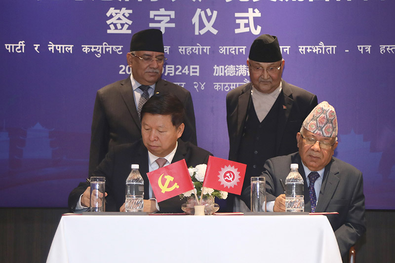 Chief of NCP (NCP)'s Foreign Affairs Department, Madhav Kumar Nepal and Chief of International Liaison Department of CPC, Song Tao signing an MoU regarding the establishment of fraternal relations between the two parties of the neighbouring nations, in the presence of Prime Minister KP Sharma Oli and Pushpa Kamal Dahal, Co-chairs of NCP (NCP), in Kathmandu, on Tuesday, September 24, 2019. Photo: RSS