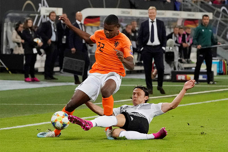 Netherlands' Denzel Dumfries in action with Germany's Nico Schulz. Photo: Reuters