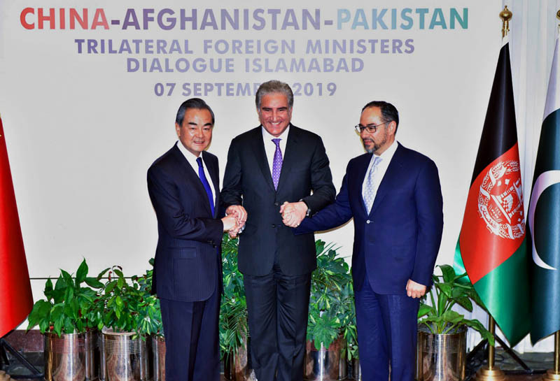 Pakistani Foreign Minister Shah Mahmood Qureshi, centre, hand shakes jointly with Afghan counterpart Salahuddin Rabbani, right, and Chinese counterpart Wang Yi prior to a meeting in Islamabad, Pakistan, Saturday, Sept, 07, 2019. Pakistan is hosting the third round of trilateral talks with Afghanistan and China to cover trade, counterterrorism and ending Afghanistan's 18-year war. Photo: Press Information Department via AP