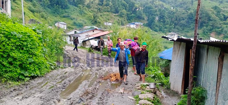 Locals carrying a patient to a health facility in Bajura district. Photo: Prakash Singh/THT
