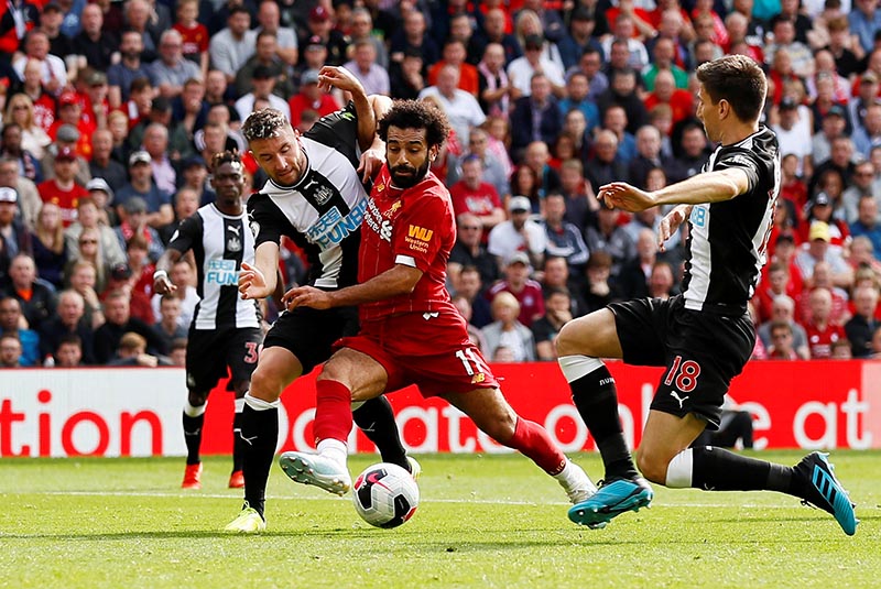 Liverpool's Mohamed Salah in action with Newcastle United's Paul Dummett and Federico Fernandez during the Premier League match between Liverpool and Newcastle United, at Anfield, in Liverpool, Britain, on September 14, 2019. Photo: Action Images via Reuters