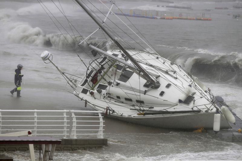 A yacht is pushed ashore by strong winds and high waves at a beach as Typhoon Tapah approaches in Ulsan, South Korea, Sunday, Sept 22, 2019. Photo: Kim Yong-tae/Yonhap via AP