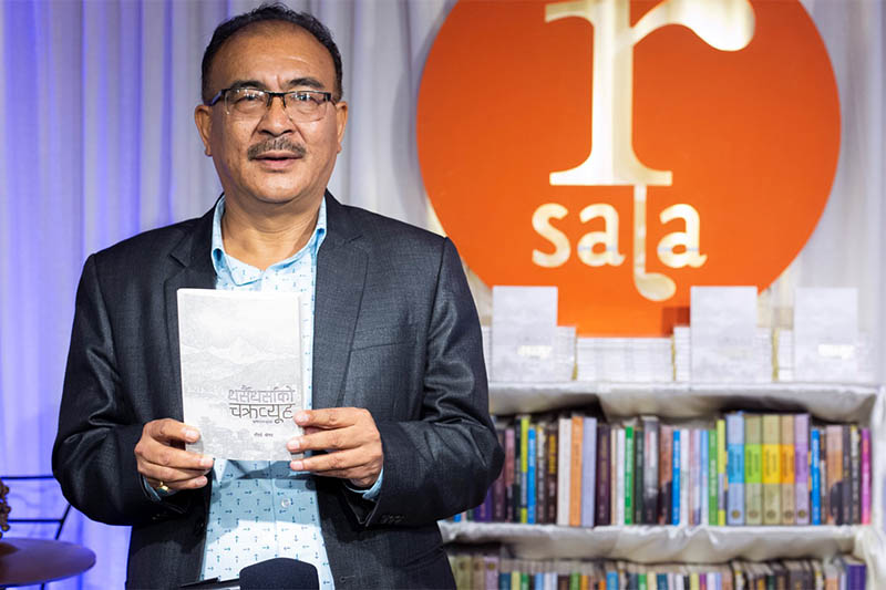 Tirtha Shrestha poses for portrait with his newly launched book at Paleti in Kathmandu, on Friday, September 27, 2019. Courtesy: Nepalaya