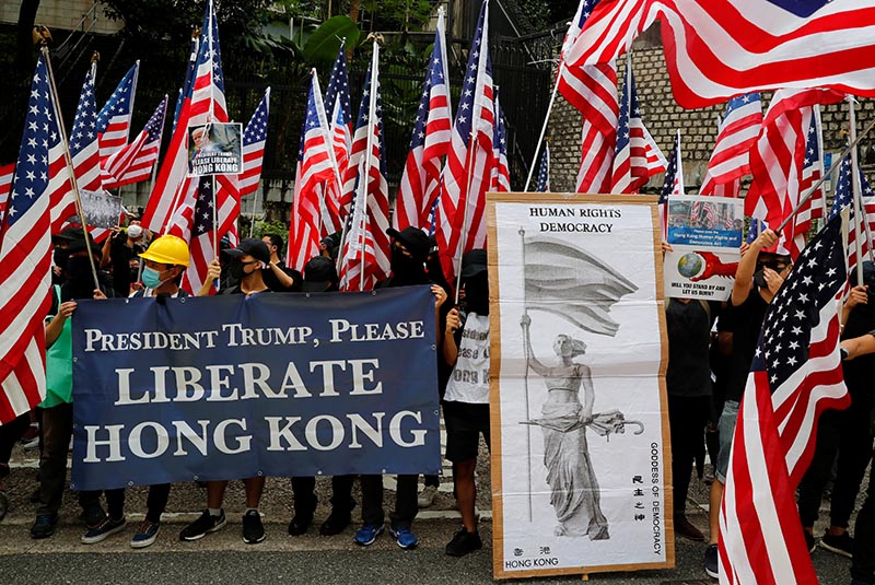Protesters hold signs and U.S. flags during a rally in Hong Kong, China on September 8, 2019. Photo: Reuters