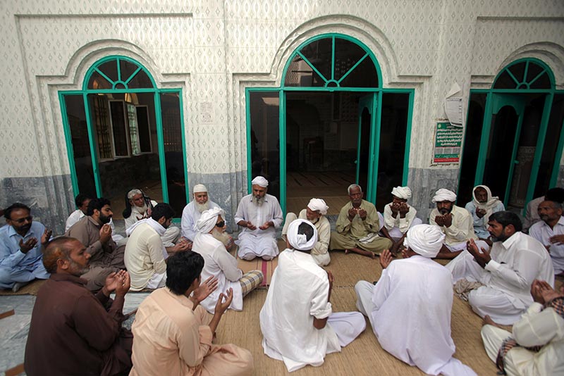 People and relatives offer condolence for eight-year-old Muhammad Faizan, who according to police was missing and his body found along with two other children, at a local mosque in Chunian, Kasur, Pakistan, September 19, 2019. Photo: Reuters