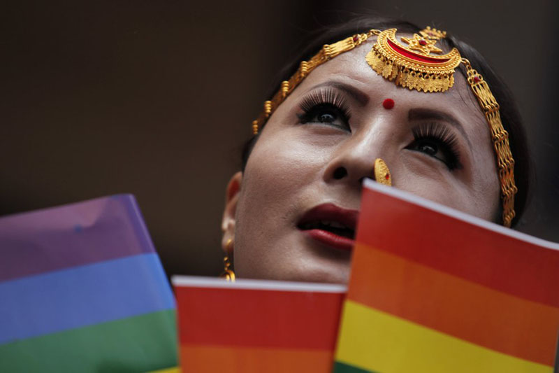 In this August 16, 2019, photo, a participant holds a rainbow flag before marching in a gay pride parade in Kathmandu, Nepal. Photo: AP