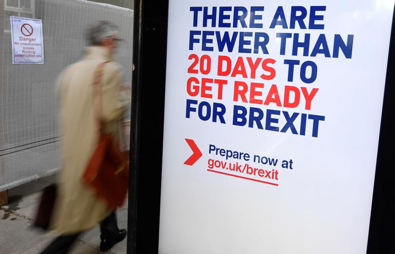 A man walks past an UK government Brexit information campaign poster at a bus stop in central London, Britain, October 15, 2019. Photo: Reuters