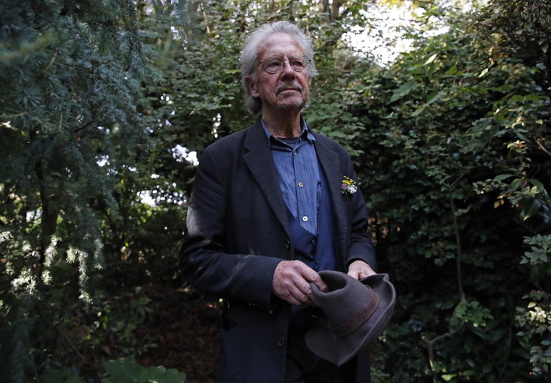 Austrian author Peter Handke poses for a photo in his garden at his house in Chaville near Paris, Thursday, Oct 10, 2019. Photo: AP