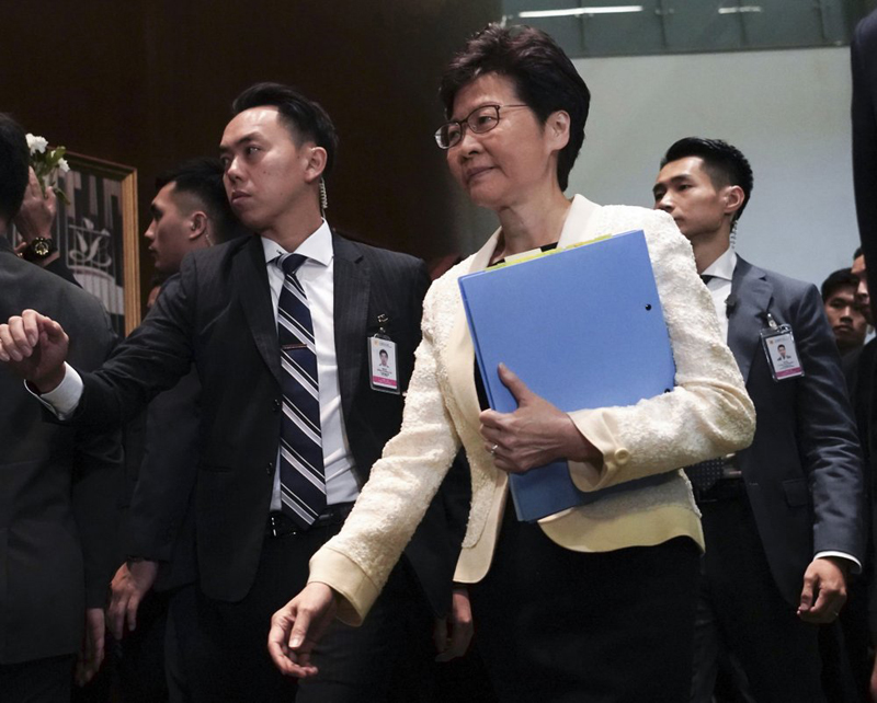 FILE - In this October 17, 2019, file photo, Hong Kong Chief Executive Carrie Lam, center, arrives at chamber of the Legislative Council in Hong Kong. Hong Kong is feuding with Taiwan over a fugitive murder suspect whose case indirectly sparked the protests in Hong Kong over an extradition bill. Photo: AP