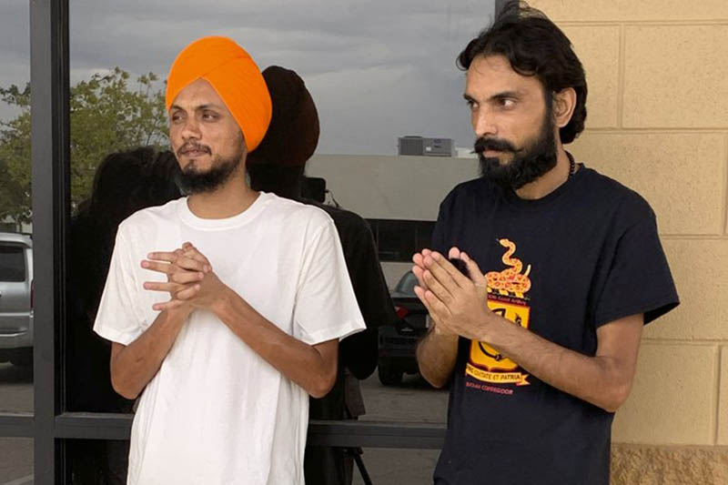 In this photo provided by attorney Jessica K. Miles, Gurjant Singh, left, stands with Ajay Kumar outside an immigration processing office in El Paso, Texas, Monday, Sept. 30, 2019. Photo: AP