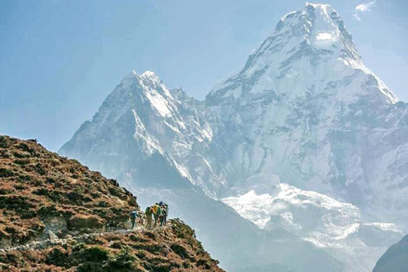 This undated image shows mountain climbers trekalong the route on the foreground of Mt Ama Dablam.