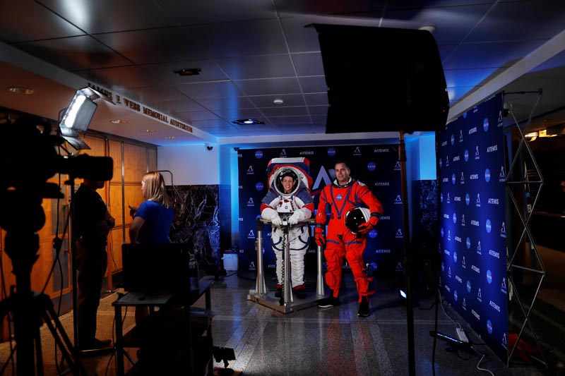 Advanced Space Suit Engineer at NASA Kristine Davis wears the xEMU space suit next to lead engineer Dustin Gohmert wearing the Orion crew survival spacesuit prototype for the next astronaut to the moon by 2024, during a presentation at NASA headquarters in Washington, US, October 15, 2019. Photo: Reuters