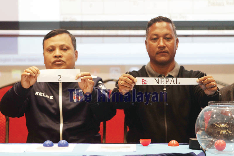 ANFA Vice-president Upendra Man Singh (right) and Deputy General Secretary Arun Man Joshi showing team and position during the draw for the 13th SA Games in Lalitpur on Friday. Photo: THT