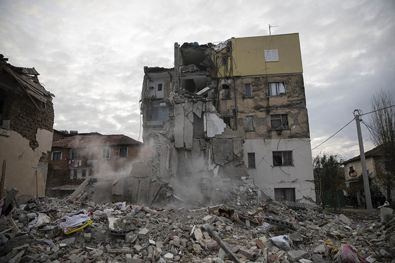 Dust rises from falling parts of a destroyed building during an aftershock in Thumane, western Albania, Wednesday, Nov. 27, 2019. Photo: AP