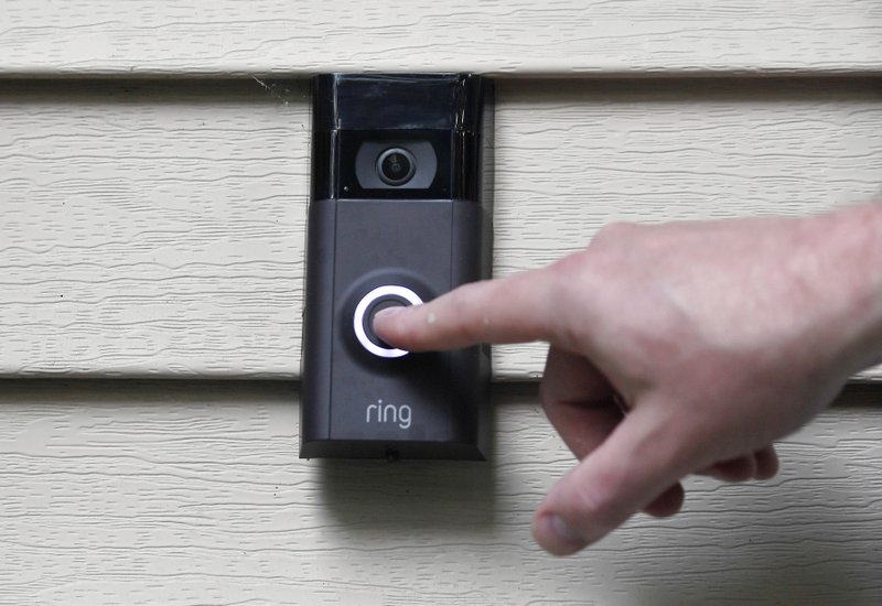 FILE - In this July 16, 2019, file photo, Ernie Field pushes the doorbell on his Ring doorbell camera at his home in Wolcott, Conn. Amazon says it has considered adding facial recognition technology to its Ring doorbell cameras. Photo: AP