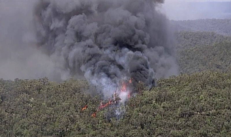 Huge plumes of smoke billow from trees on fire in Gospers Mountain, New South Wales, Australia, Friday, Nov 15, 2019. Photo: Australia Pool via AP