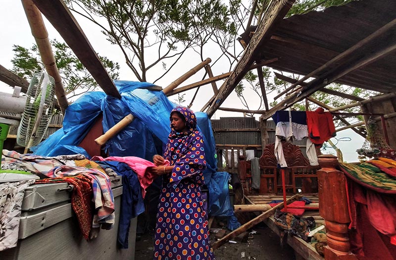 A woman is seen inside her damaged house after cyclone Bulbul hit the area in Khulna, Bangladesh, November 10, 2019. Photo: Reuters