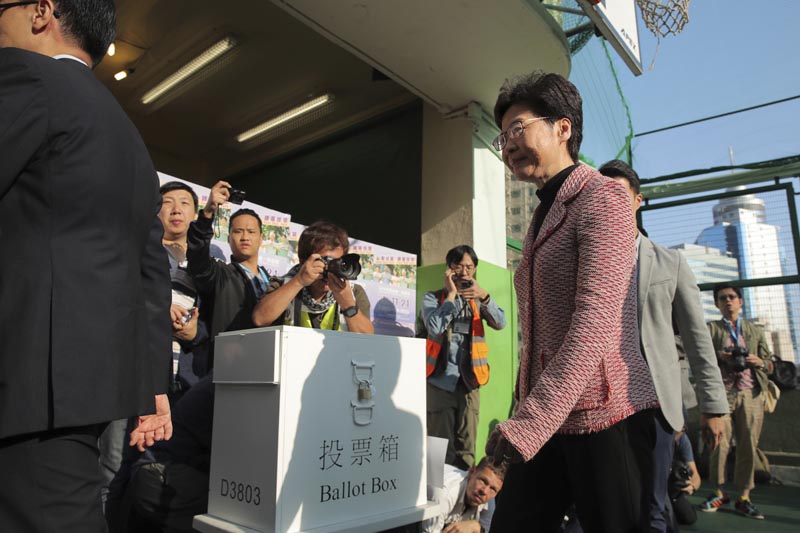 Hong Kong Chief Executive Carrie Lam leaves after casting her ballot at a polling place in Hong Kong, Sunday, November 24, 2019. Photo: AP