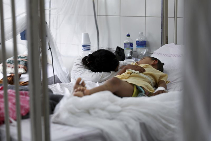 In this August 20, 2019 file photo, a relative embraces a young patient receiving treatment for dengue at the University School Hospital in Tegucigalpa, Honduras. Photo: AP
