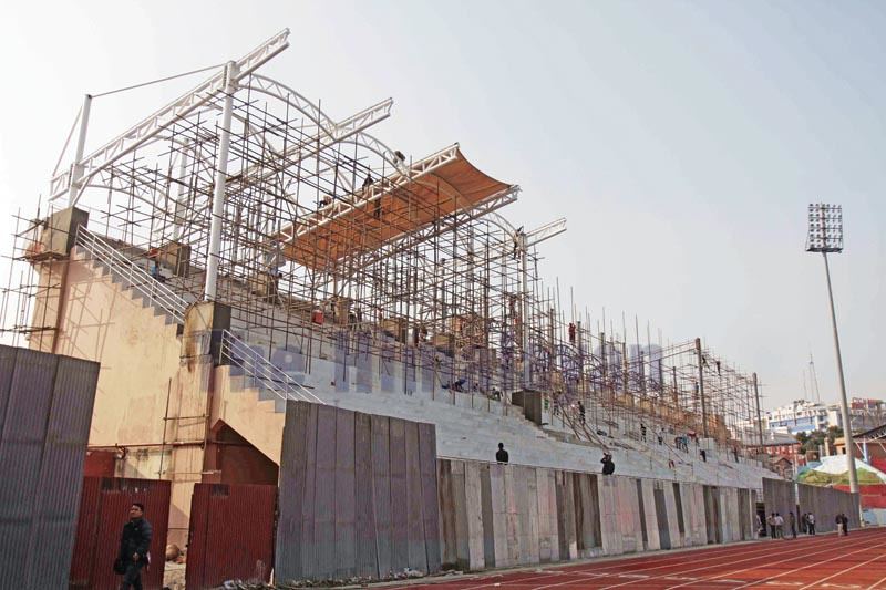 Workers installing fabric roof over the VIP stands parapet at the Dasharath Stadium, the main venue for the 13th South Asian Games scheduled for December 1-10, in Kathmandu on Wednesday, November 20, 2019. Photo: Udipt Singh Chhetry/ THT