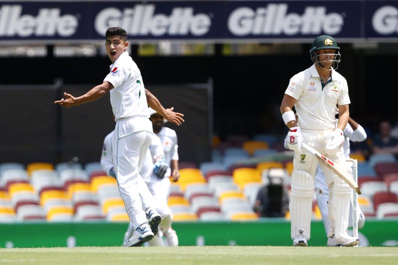Pakistan's Naseem Shah, left, celebrates the wicket of Australia's David Warner, right, before the decision was overturned due to a no ball called during their cricket test match in Brisbane, Australia, Friday, November 22, 2019. Photo: AP