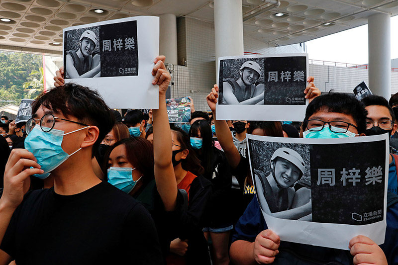 Students hold images of Chow Tsz-Lok, 22, a university student who fell during protests at the weekend and died early on Friday morning, during a ceremony to pay tribute to him at the Hong Kong University of Science and Technology, in Hong Kong, China, on November 8, 2019. Photo: REUTERS