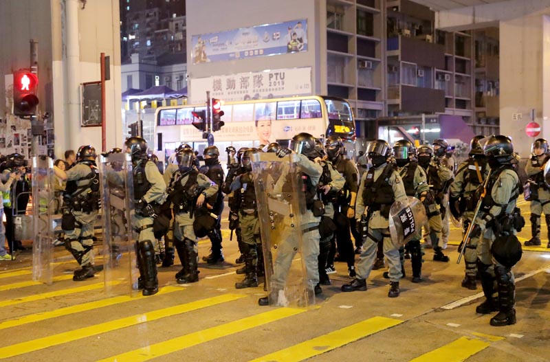 Riot police officers block the street as anti-government protesters rally outside Prince Edward MTR station in Hong Kong, China, November 30, 2019. Photo: Reuters