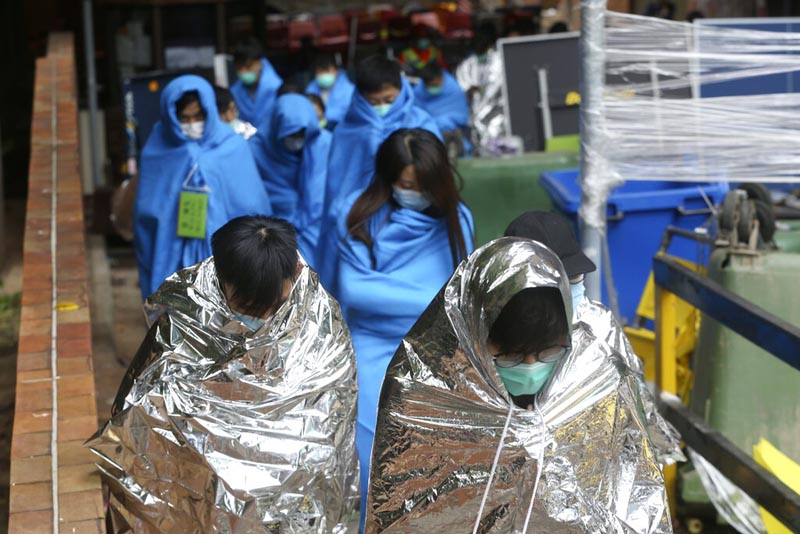 Injured protesters huddle under blankets as they walk at the Hong Kong Polytechnic University in Hong Kong, Tuesday, November 19, 2019. Photo: Reuters