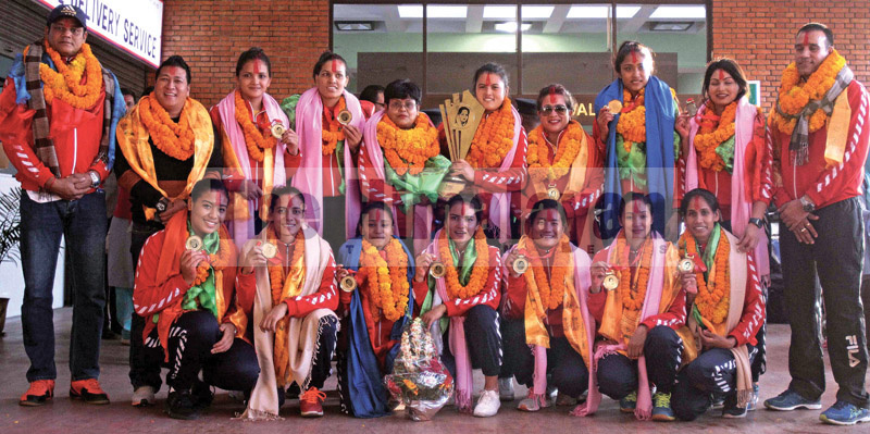 Nepal national women’s volleyball team members pose for a group photo upon their arrival at the Tribhuvan International Airport, in Kathmandu, on Friday, November 15, 2019. Photo: Udipt Singh Chhetry/THT